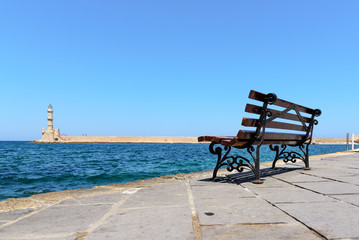 Bench with view on lighthouse of Chania town on Crete island, Greece
