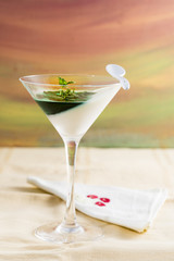 panna cotta with mint syrup and fresh leaves