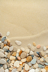 Fototapeta na wymiar Sand background with pebbles. Sandy beach texture