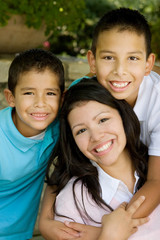 Happy Hispanic mother and her sons.