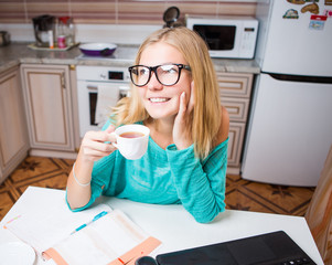 Woman with cup in kitchen