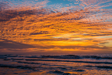 Waves in the Atlantic Ocean at sunrise, in Folly Beach, South Ca