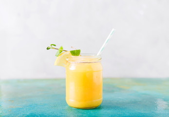 Orange juice. Orange smoothie on a turquoise background..Kiwi. Cocktails. Detox Juice. Summer drink. Healthy food concept