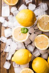 Lemons and ice on a wooden background. Lemons. Fruits. Kiwi. Mint. Healthy food concept. Copyspace