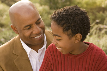 Fototapeta premium African American father and son talking and laughing.