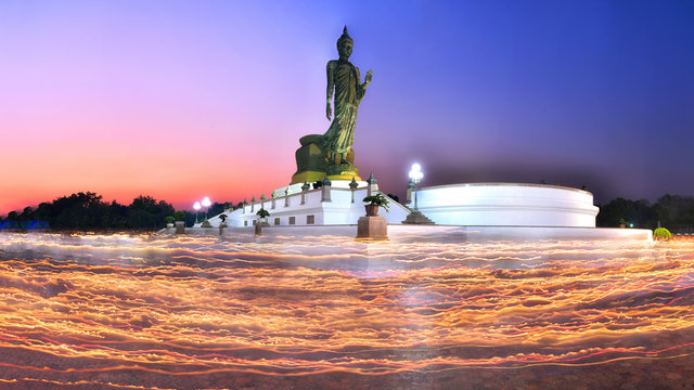 Many people are candlelit around the Buddha on Visakha Bucha Day at Buddhamonthon Nakornpathom Province, Thailand