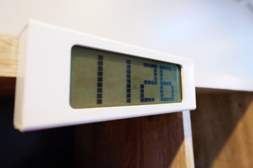 11:26 clock digital on bookcase