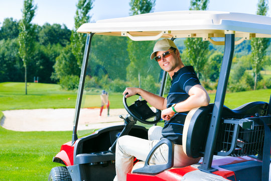 Man Driving A Golf Cart