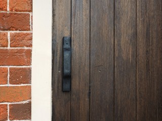 Closeup old wooden door on brick wall