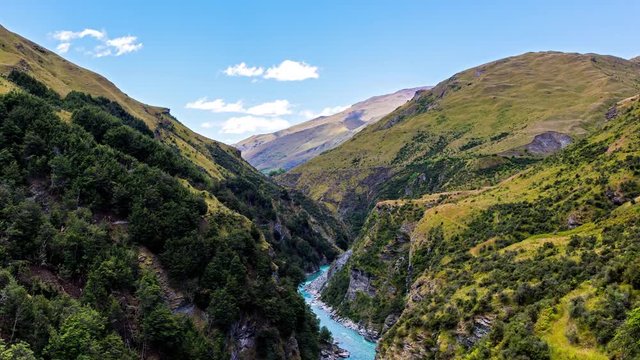 time-lapse of the Shotover canyon and the beautiful blue waters of it’s river surrounded by mountains during a summer and sunny day