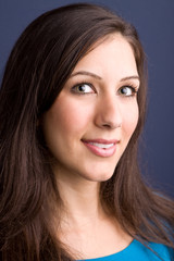 Obraz premium Happy woman sitting in a red chair.