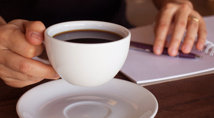 Fototapeta na wymiar Hot cup of coffee on working table