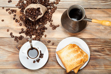 Obraz na płótnie Canvas Breakfast, toast and coffee on a wooden background