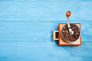 Coffee grinder on blue background