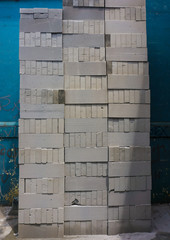 Stacking con blocks in a vertical way near blue wall photo taken in Bogor Indonesia