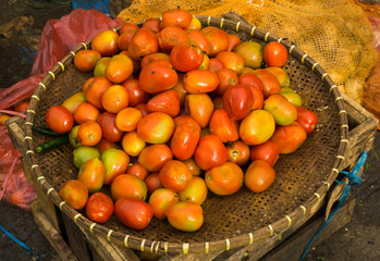 Red tomatoes on a bamboo basket photo taken in Bogor Indonesia