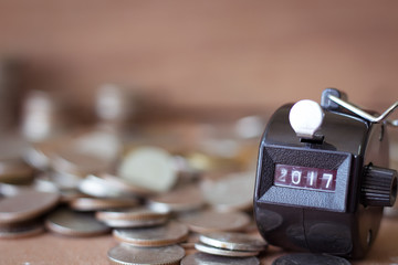 2017 number counter and blur coin on blur wood background