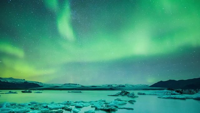 Amazing northern light aurora in glacier lake in Iceland - 4K