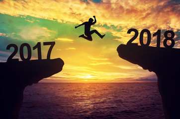 A man jump between 2017 and 2018 years. - obrazy, fototapety, plakaty