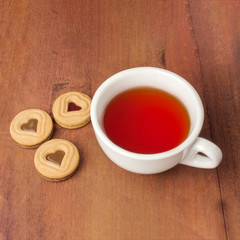 Tea cup and butter cookies with heart-shaped filling