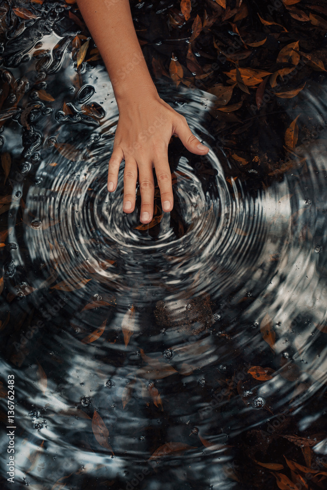 Canvas Prints woman hand making circles on water