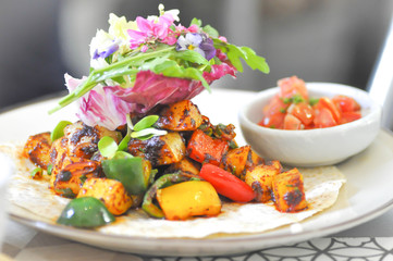 tortilla or taco with tomato , sweet pepper and salsa