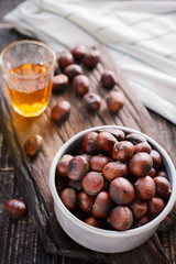 chestnuts with roasted coffee beans on wooden background. Top view selective focus.