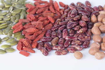 Dry pumpkin seeds, peanuts, beans, wolfberry on white background.