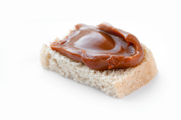 Bread with cooked condensed milk on a white background