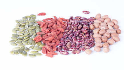 Dry pumpkin seeds, peanuts, beans, wolfberry on white background.