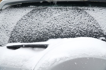 close up on snow on rear window of vehicle