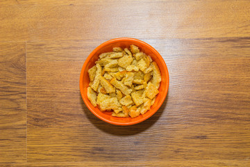 Bread rusks and croutons in orange plate.