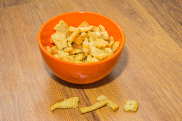 Bread rusks and croutons in orange plate.