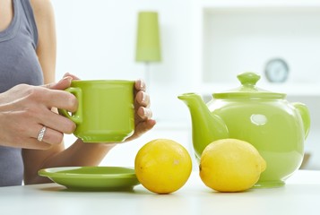High key pastel still life of tea kettle mug lemon