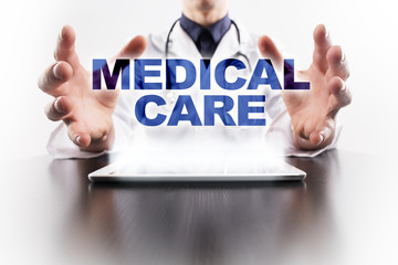 Medical doctor using tablet PC with medical care medical concept.