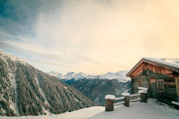 Fototapeta na wymiar Alpine hut covered by the snow