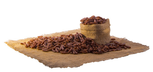 brown pasta with grape seeds in a small sack