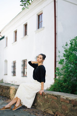 Fototapeta premium Young beautiful woman walking through the streets of the old town