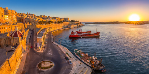 Valletta, Malta - Panoramic skyline view of Valletta and the Grand Harbor with beautiful sunrise,...