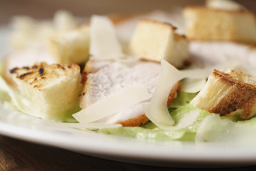 closeup shot of fresh simple caesar salad with chicken, shallow depth of field