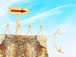 Road sign shows the way to an abyss. Conceptual image with wooden puppets