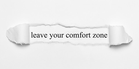 leave your comfort zone on white torn paper