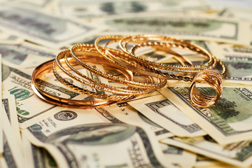 Golden jewelry and money. Expensive and unrighteous lifestyle.