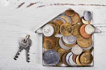 Coins in house-shaped form, keys. Purchase of dream.