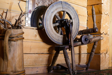 Traditional devices, vintage tailoring equipment concept. Old fashioned wooden distaff, spindle,...