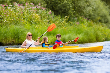 Family enjoying kayak ride on a river