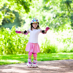 Little girl with roller skate shoes in a park