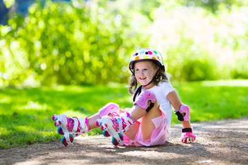 Little girl with roller skate shoes in a park