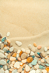 Fototapeta na wymiar Sand background with pebbles. Sandy beach texture