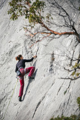 woman climbs a rock